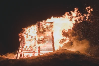A building on fire at night.